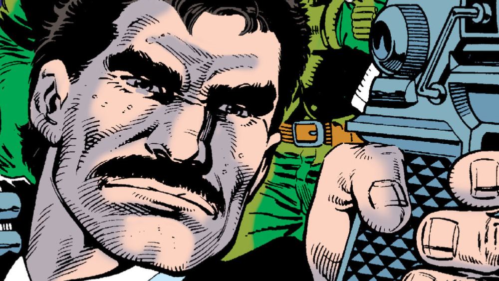 Bruno Mannheim en gros plan, moustache et veste verte, main sur une arme, dans les comics